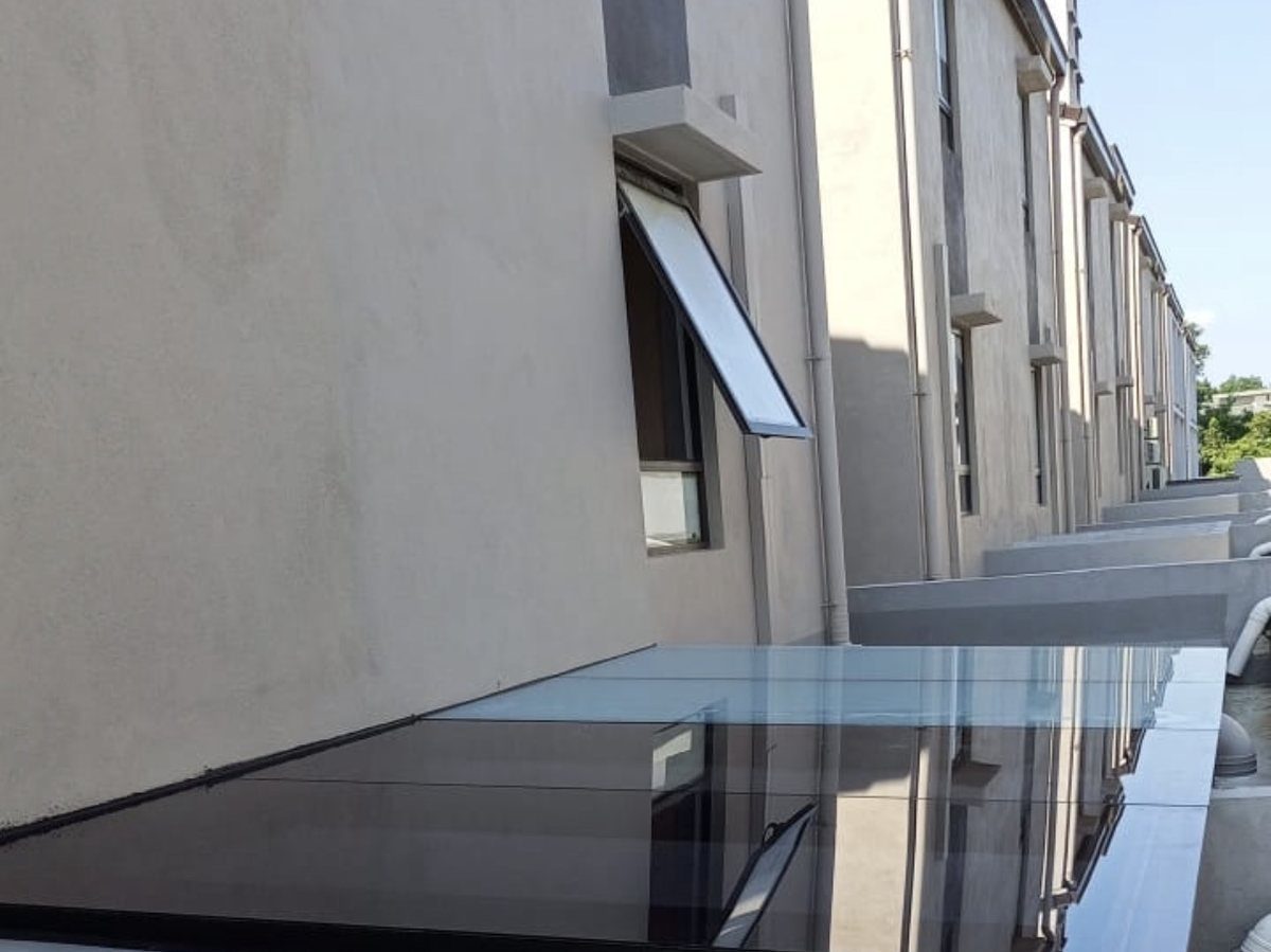Tinted flat glass skylight panel on a rooftop terrace — CLEV installation
