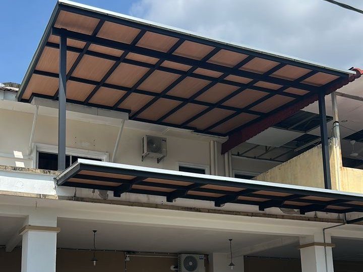Grid-pattern polycarbonate Urban Comfort awning over a terrace house driveway — CLEV installation